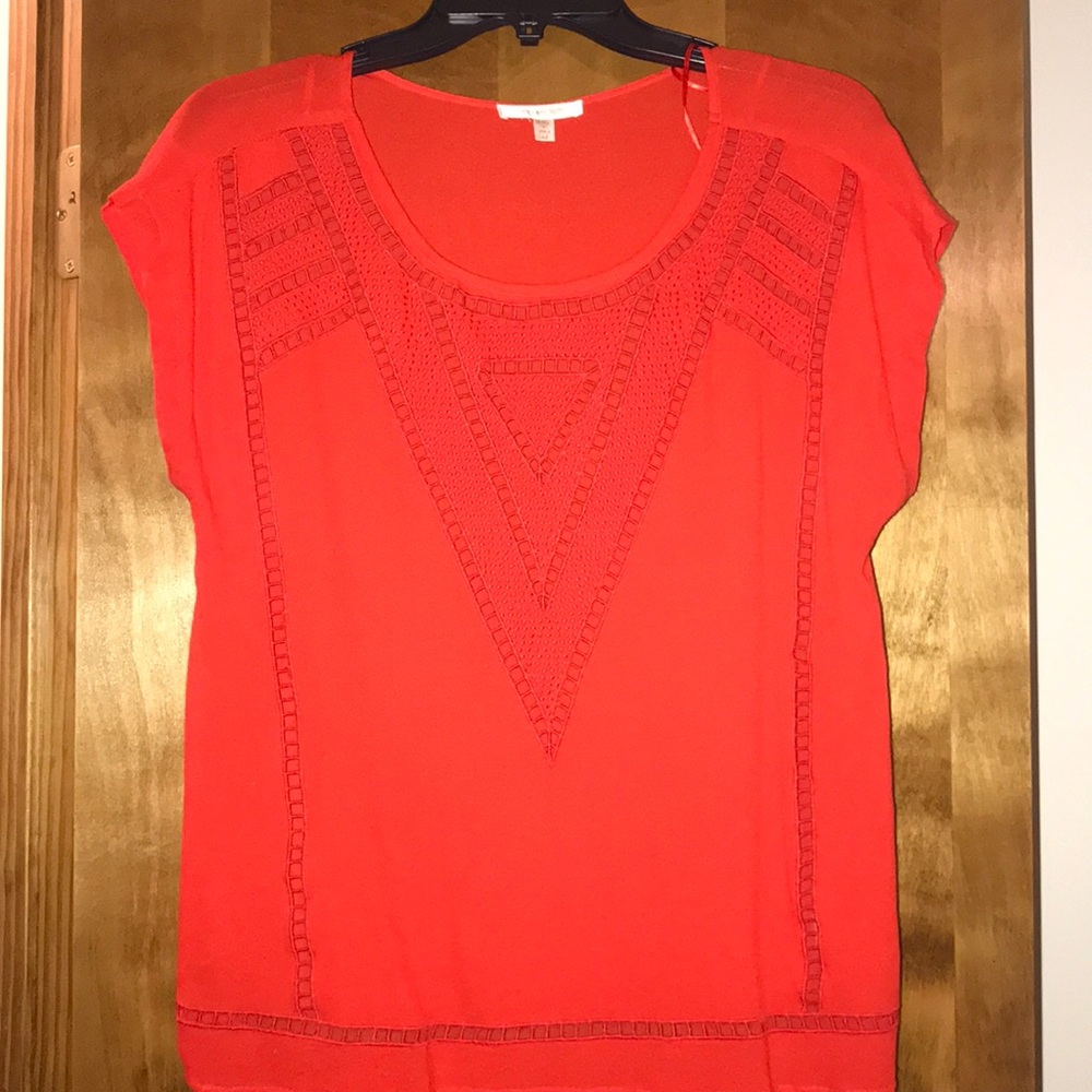 Laser cut blouse.